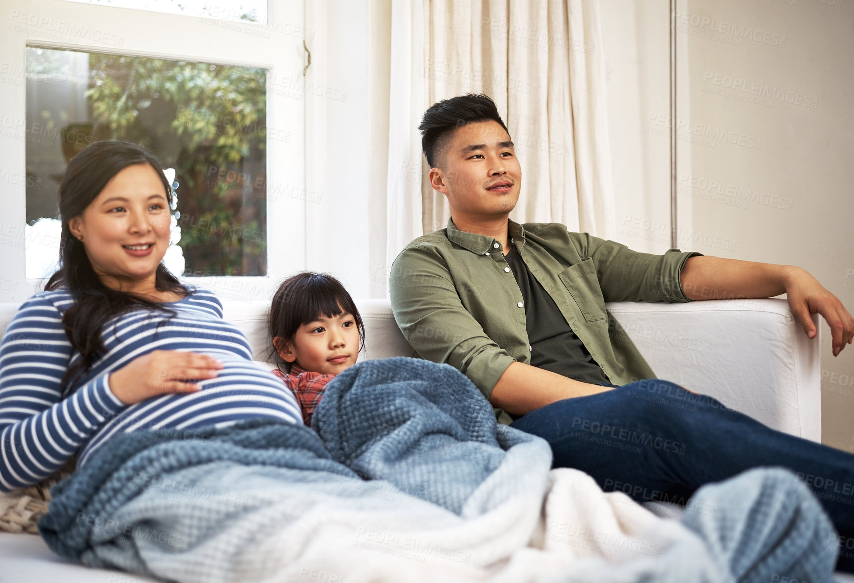 Buy stock photo Relax, sofa and family in home watching tv with movie, film or show with bonding together. Happy, weekend and Asian kid with father and pregnant mother for streaming series in living room at house.
