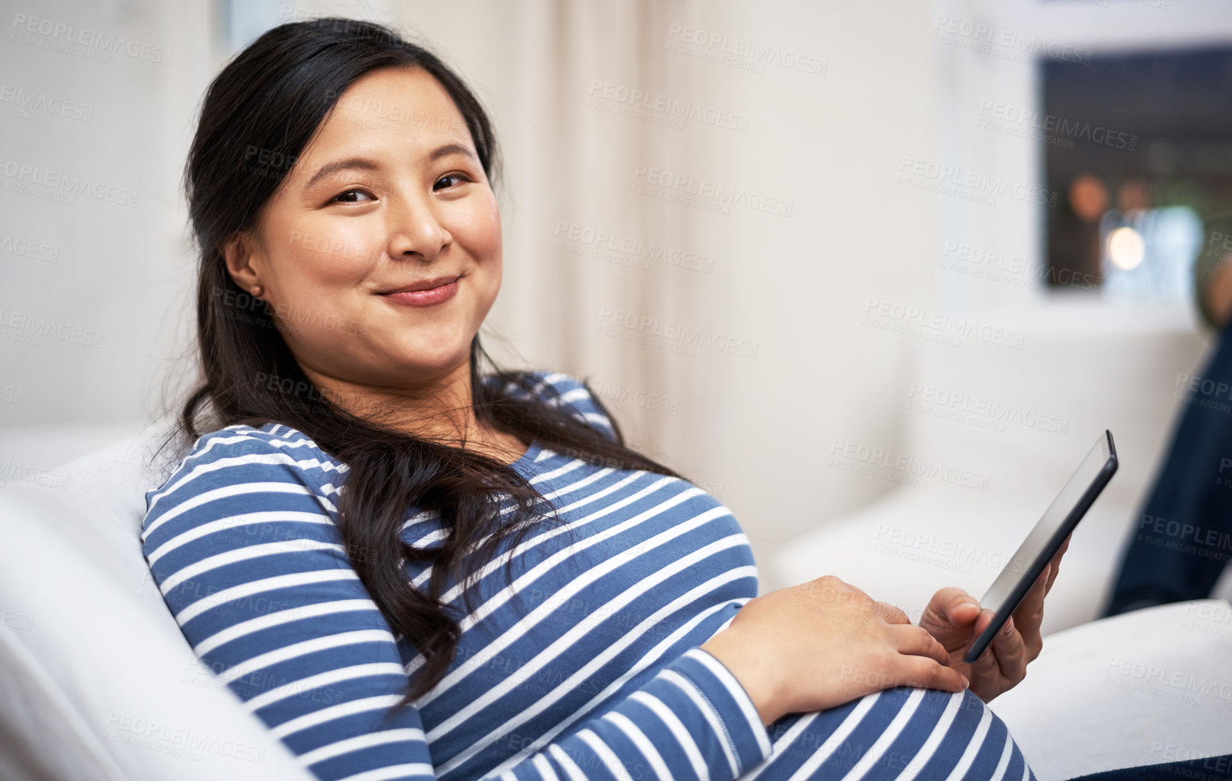 Buy stock photo Tablet, smile and portrait of pregnant woman in home with reading blog for maternity tips. Happy, relax and Asian female person with digital technology for research on pregnancy wellness in house.
