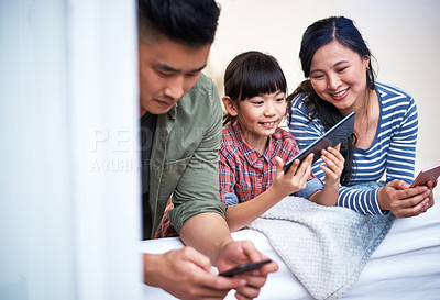 Buy stock photo Shot of a family using digital devices at home
