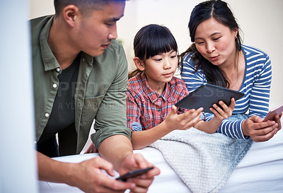 Buy stock photo Shot of a family using digital devices at home