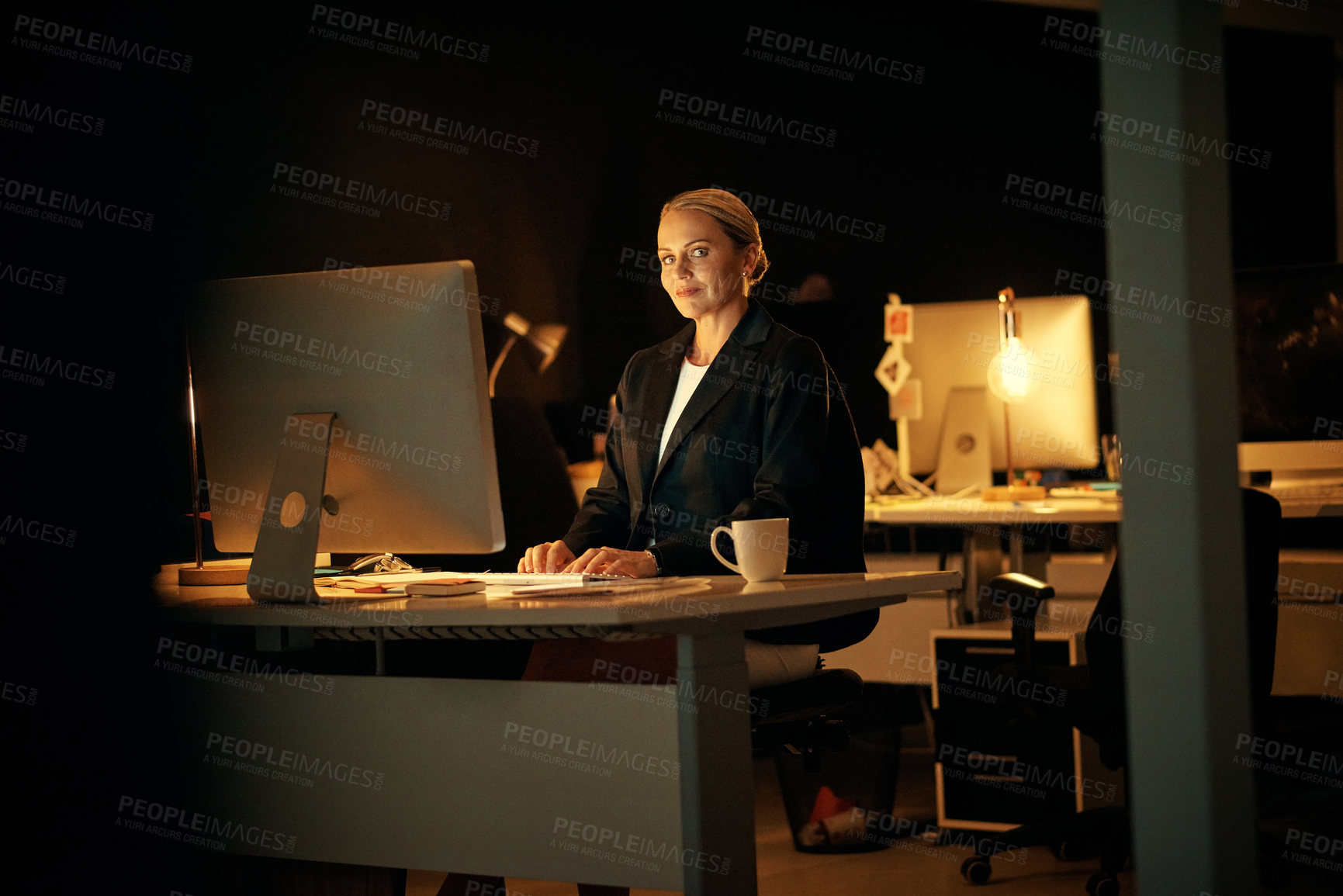 Buy stock photo Happy woman, computer and night at startup for review, project and editing article at media company. Person, pc and journalist in portrait, smile or overtime for report at creative agency in Germany