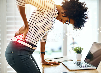 Buy stock photo Cropped shot of a young businesswoman holding her back in discomfort