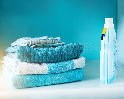 Buy stock photo Washing machine, towel and clean laundry in blue background with stack, product and mockup. Lens flare, fabric and electrical for energy, efficiency and furniture with stain removal for clothes