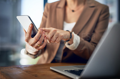 Buy stock photo Closeup shot of an unrecognizable businesswoman using her cellphone in an office