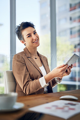 Buy stock photo Portrait of a businesswoman working on a digital tablet in an office