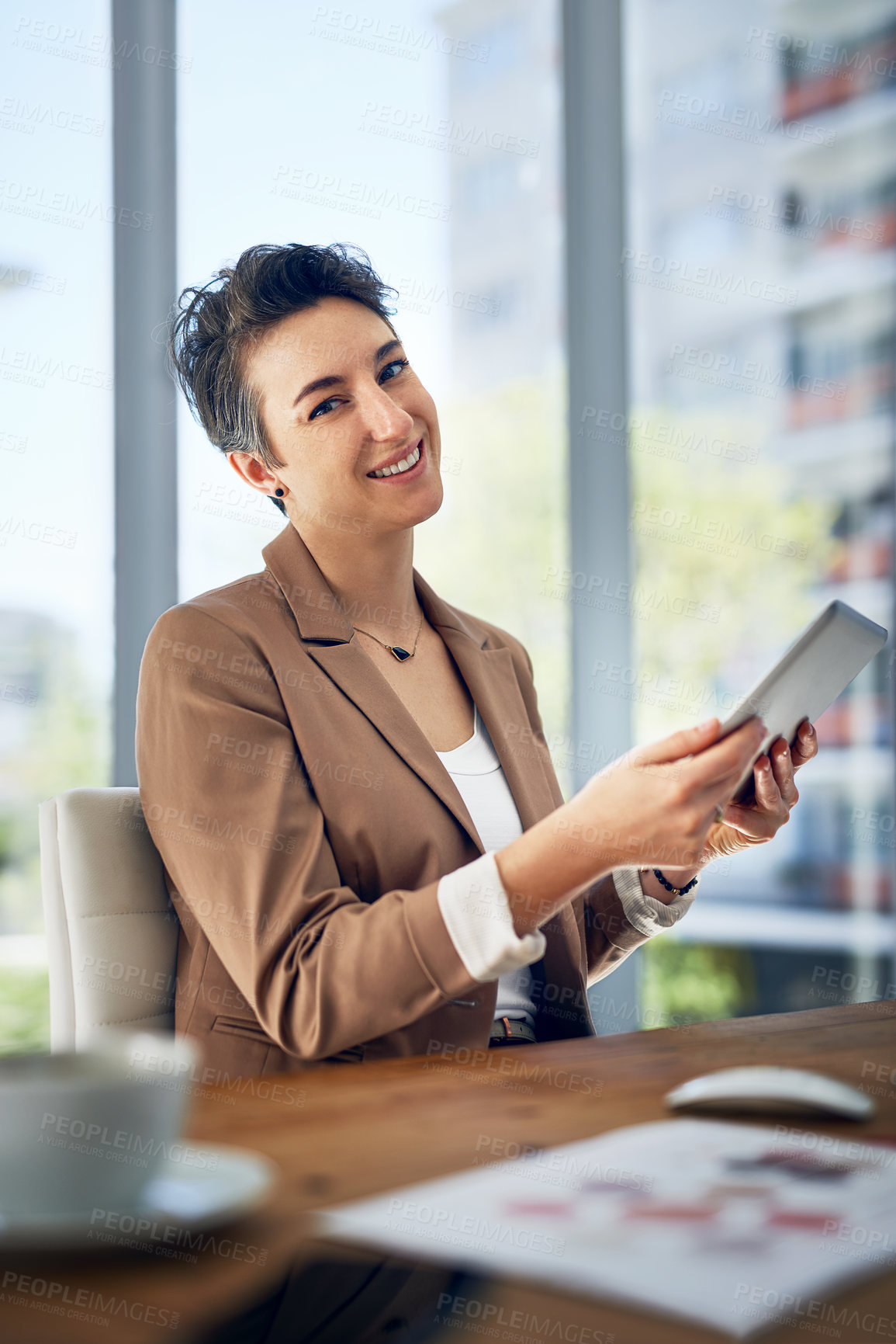 Buy stock photo Portrait of a businesswoman working on a digital tablet in an office