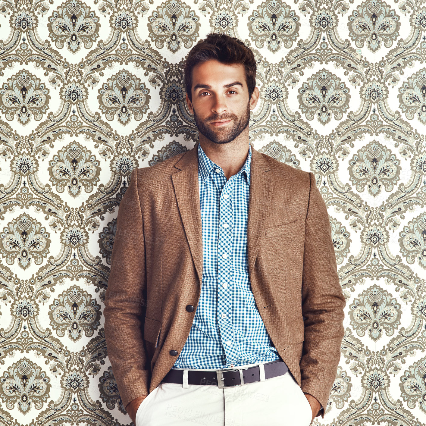 Buy stock photo Portrait of a stylishly dressed young man posing against a wallpaper background