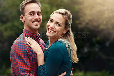 Buy stock photo Portrait of an affectionate young couple spending quality time together outdoors