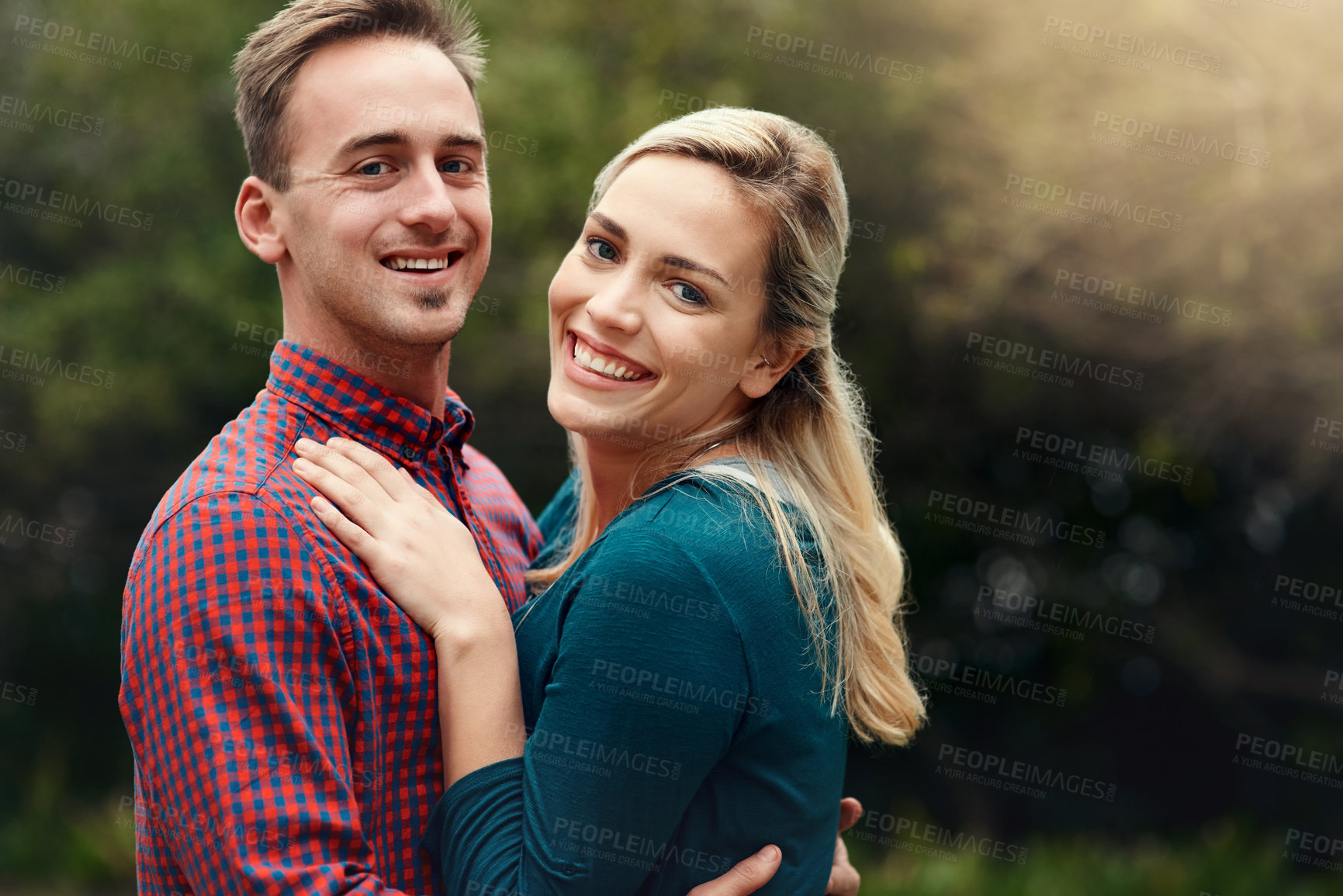 Buy stock photo Portrait of an affectionate young couple spending quality time together outdoors