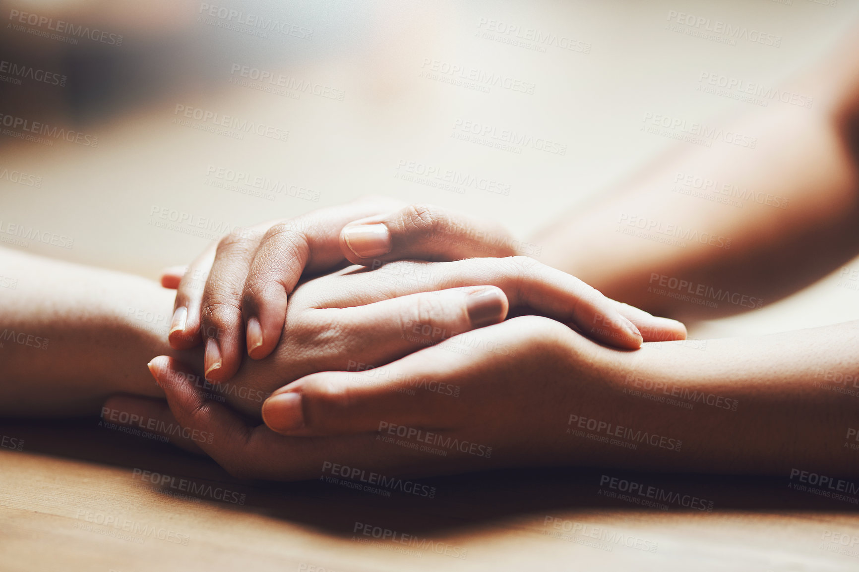 Buy stock photo Prayer, empathy and support with people holding hands in comfort, care or understanding on a wooden table of a home. Love, faith or depression with friends closeup for help, hope or peace for healing