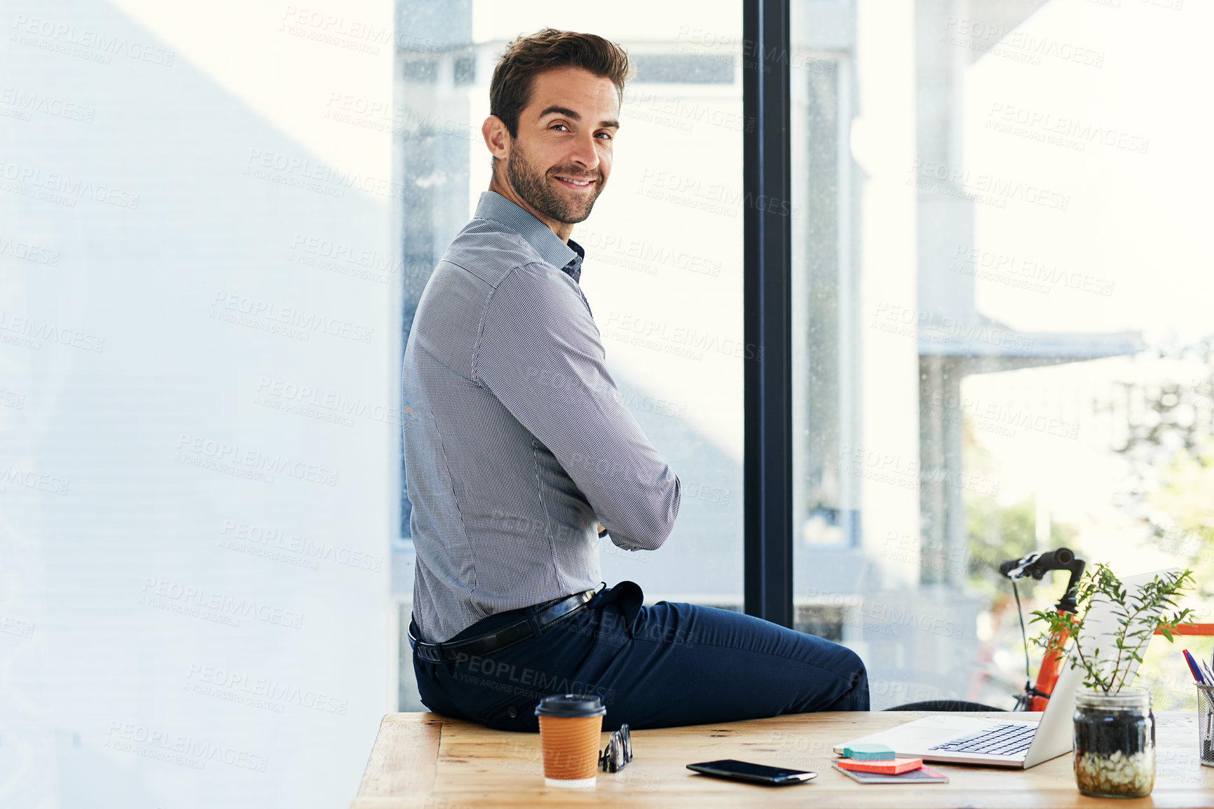 Buy stock photo Portrait, business man and happy with laptop in desk at office in startup company as graphic designer. Entrepreneur, table and confident at creative agency for career, job and opportunity with pride