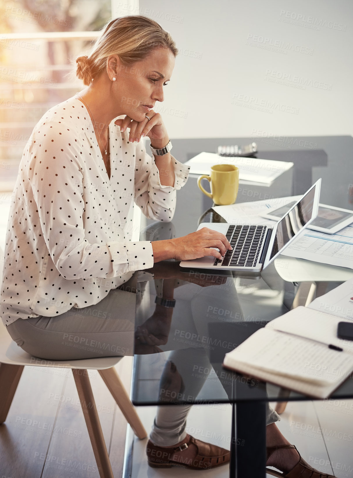 Buy stock photo Cropped shot of a mature businesswoman working from her home office