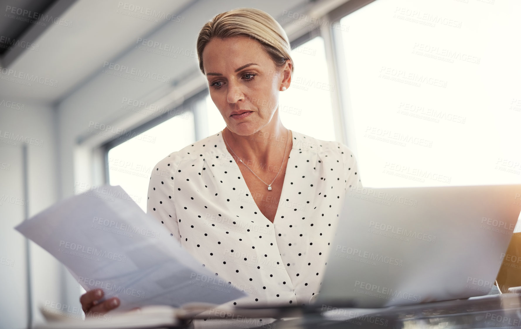 Buy stock photo Cropped shot of a mature businesswoman working from her home office