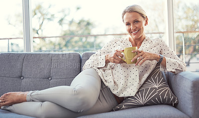 Buy stock photo Shot of a happy mature woman relaxing on the sofa at home