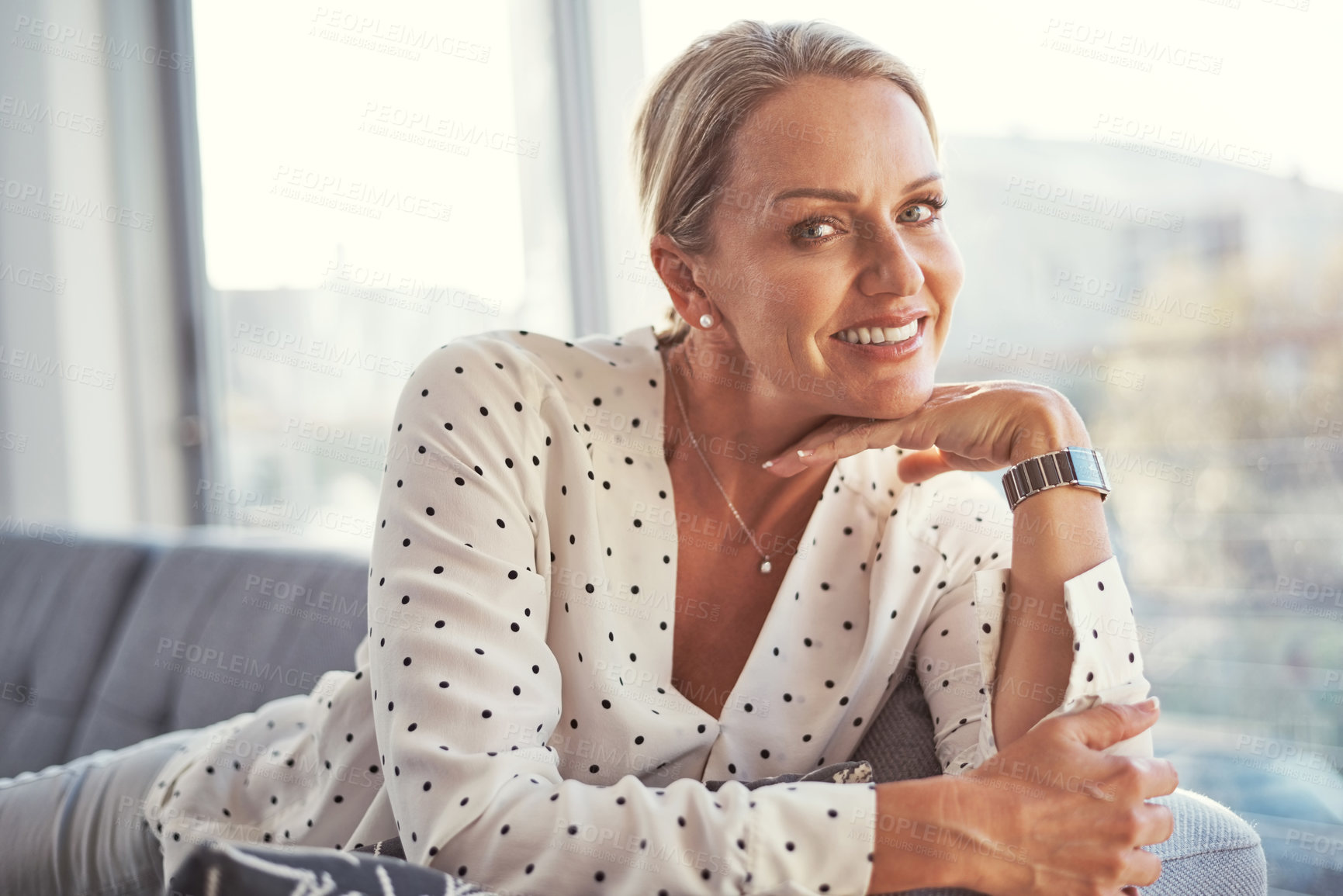 Buy stock photo Shot of a happy mature woman relaxing on the sofa at home