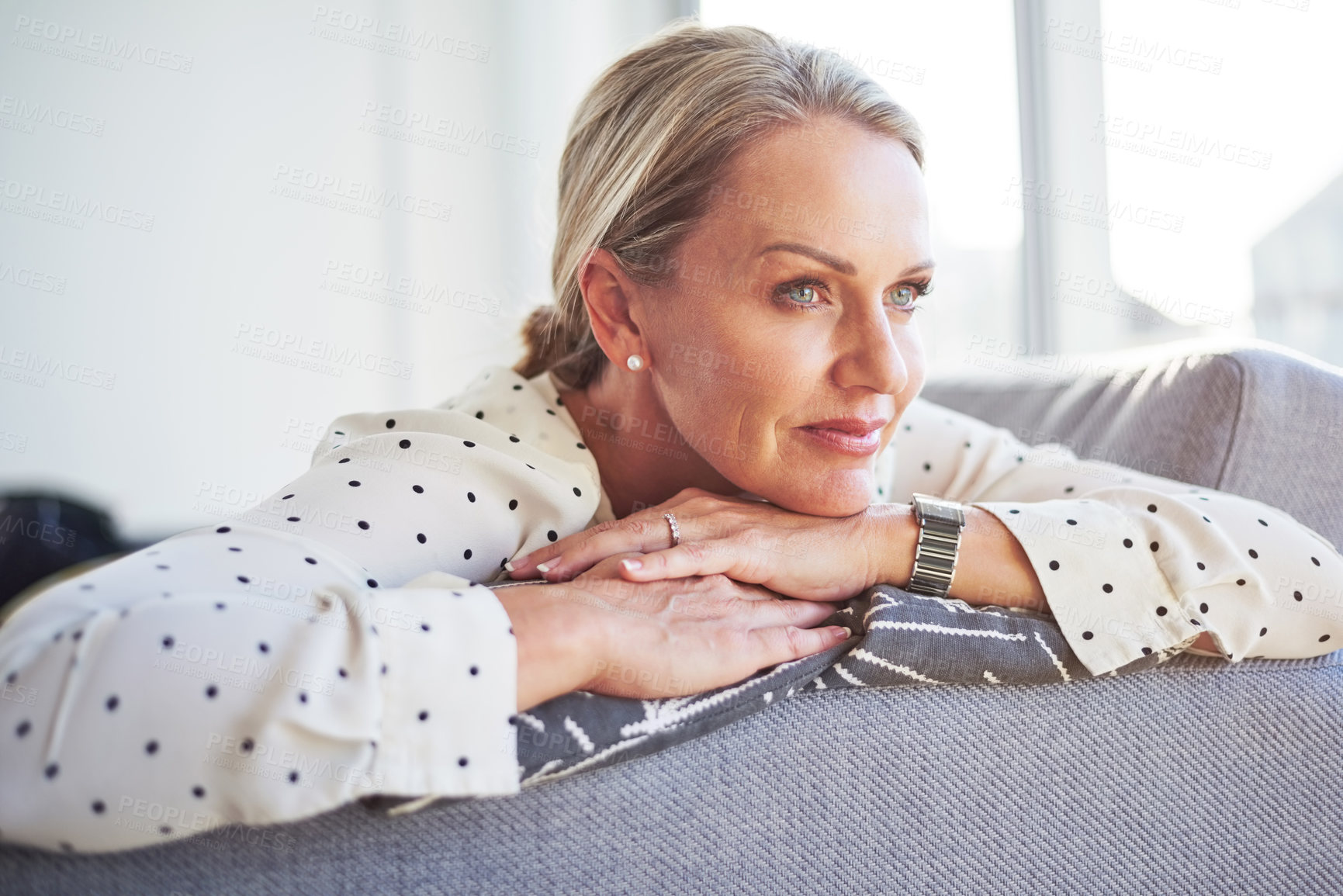 Buy stock photo Shot of a happy mature woman relaxing on the sofa at home