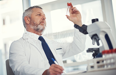 Buy stock photo Shot of a mature man conducting medical research in a laboratory