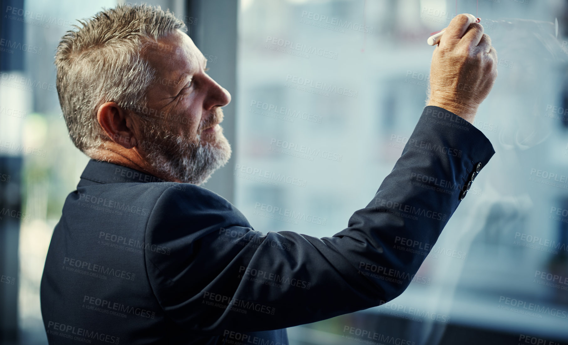 Buy stock photo Shot of a mature businessman having a brainstorming session against a glass screen in a modern office