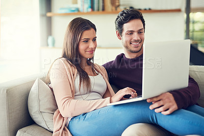 Buy stock photo Laptop, love and couple on sofa in living room browsing for movie, show or film together at home. Happy, technology and people relaxing and streaming funny, comic or comedy video on computer at house
