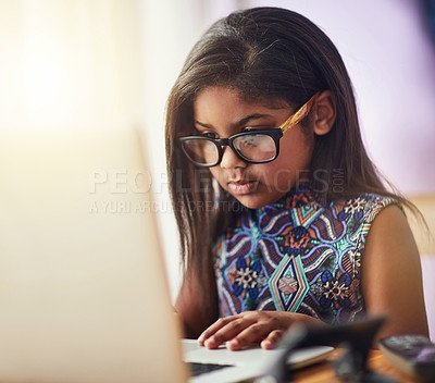 Buy stock photo Shot of a cute little girl using a laptop in her bedroom at home