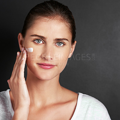 Buy stock photo Studio background, skincare and woman in portrait with moisturizer for face, care and healthy skin with mockup. Female person, facial routine or glow in morning with treatment or cosmetics or smile