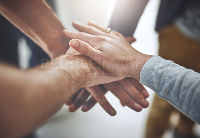 Buy stock photo Closeup shot of a group of unidentifiable businesspeople joining their hands together in unity
