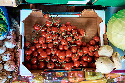 Buy stock photo Above, produce and cherry tomatoes in box for sale, small business or vegetables in marketplace. Farm stall, harvest or fruit in package for display, local startup or grocery for antioxidants or diet