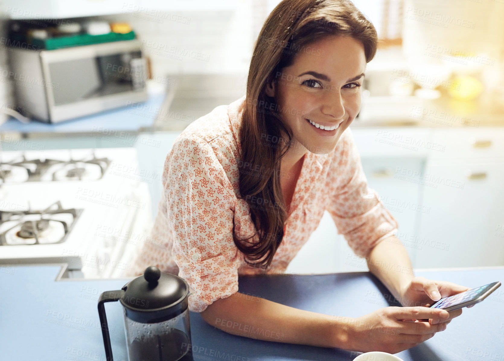 Buy stock photo Phone, smile and portrait of woman in kitchen at house networking on social media, internet or mobile app. Happy, cellphone and female person reading email or text in morning for connectivity at home