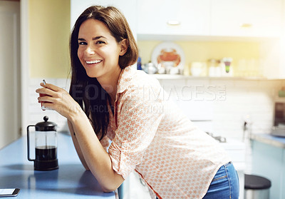 Buy stock photo Portrait of an attractive young woman having a cup of coffee at home