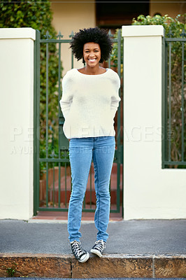 Buy stock photo Portrait of a happy young woman standing on the sidewalk outside of her home