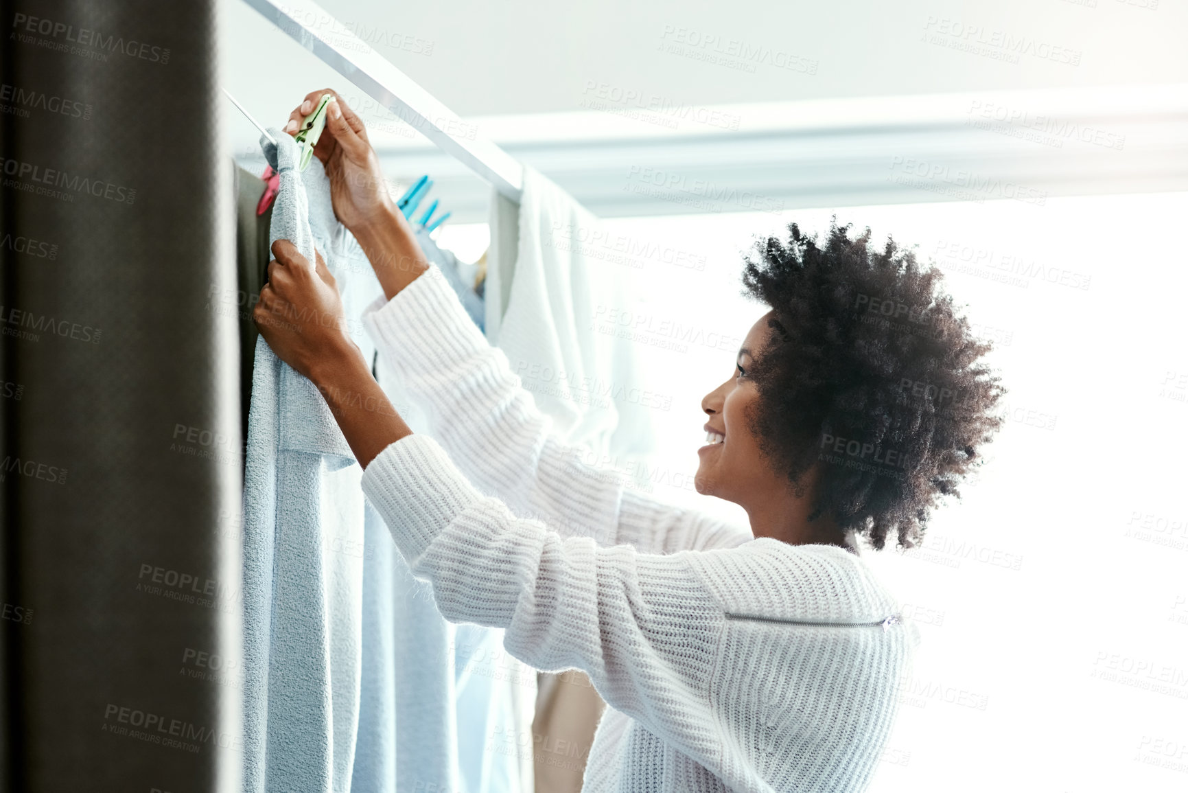 Buy stock photo Black woman, home and smile with hanging clothes for housekeeping, duties and domestic. Female person, washing and laundry with happiness for cleaning, hygiene and chores on day off and enjoy.