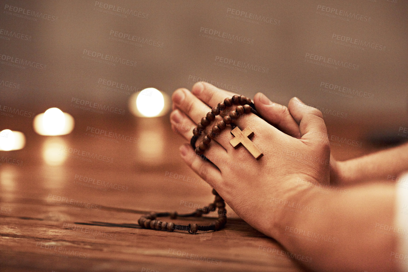 Buy stock photo Person hands praying holding a rosary with cross of Christian faith, religion or tradition in a religious church closeup and background. Man Catholic church with prayer hands and spiritual devotion