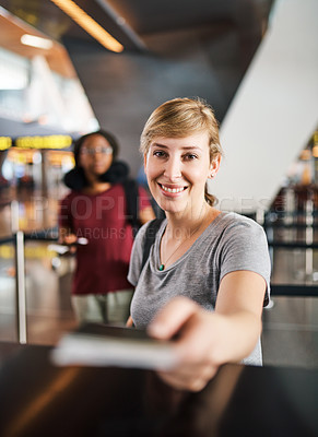 Buy stock photo Cropped portrait of an attractive young woman handing over her passport at a boarding gate in an airport