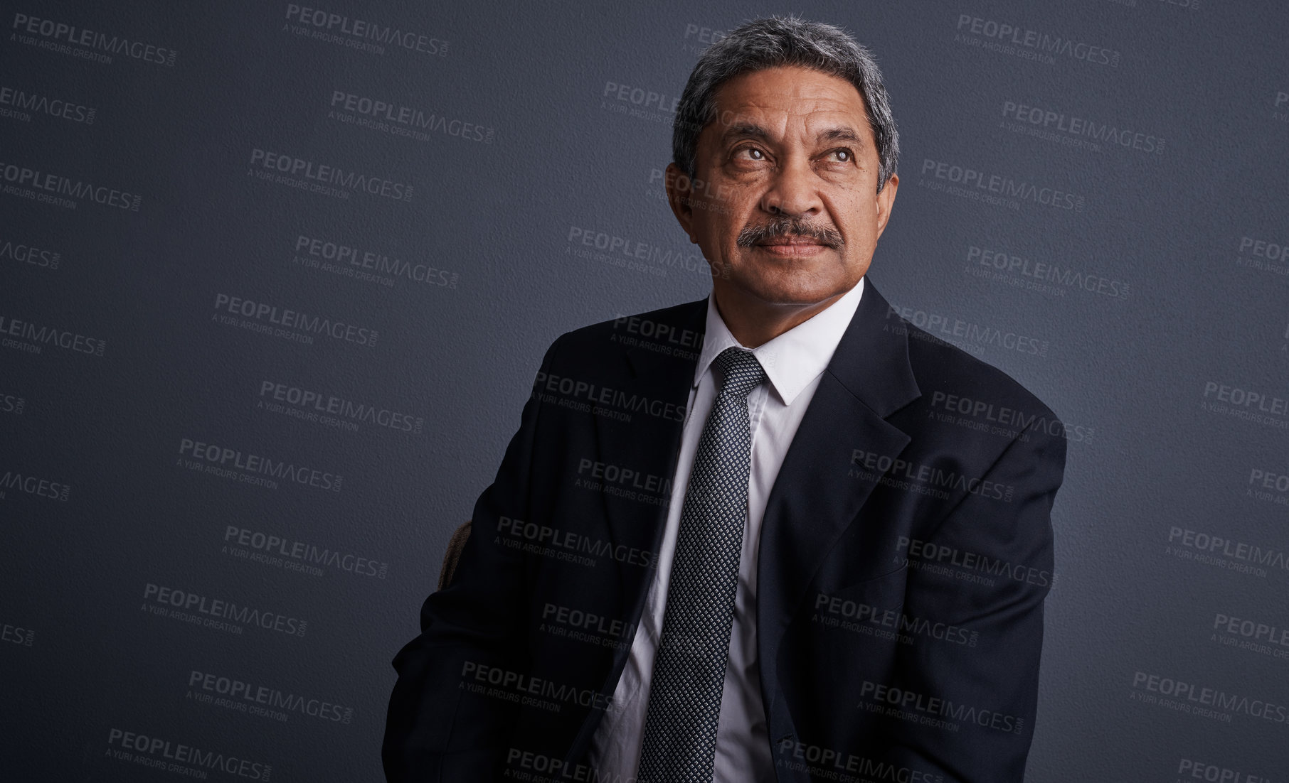 Buy stock photo Studio shot of a mature businessman posing against a dark background 