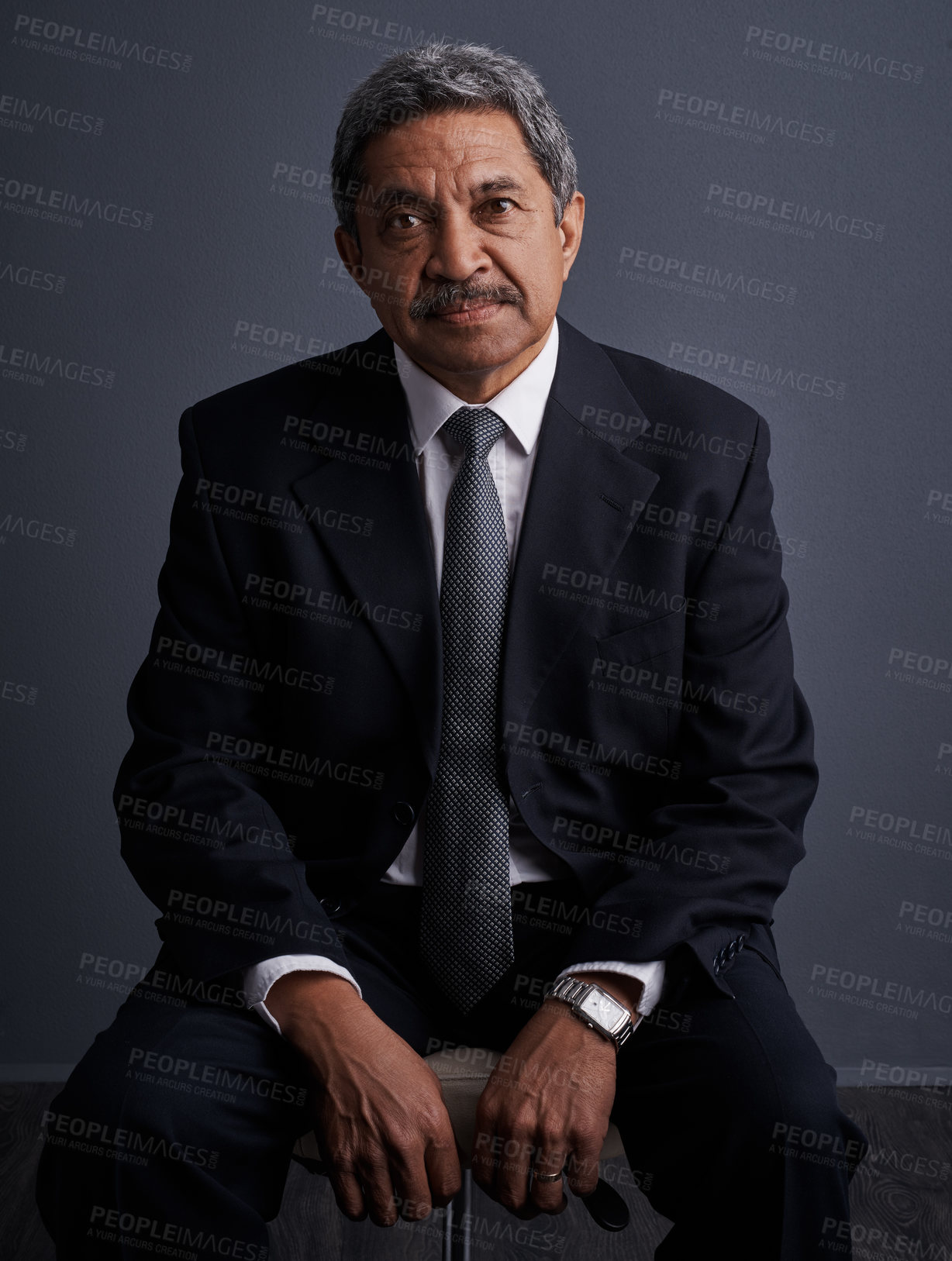 Buy stock photo Studio shot of a mature businessman posing against a dark background 