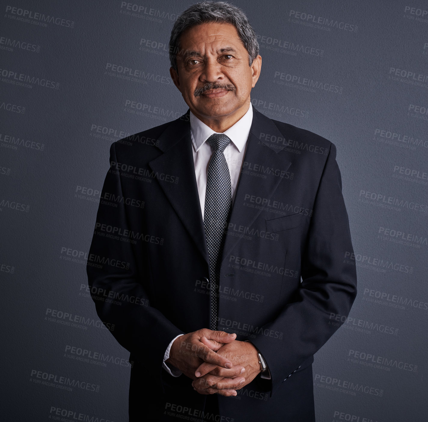 Buy stock photo Studio shot of a mature businessman posing against a dark background 