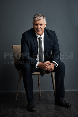 Buy stock photo Studio shot of a mature businessman posing against a grey background