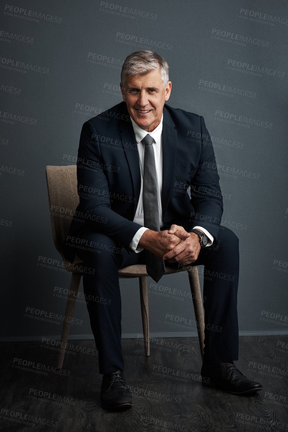 Buy stock photo Studio shot of a mature businessman posing against a grey background