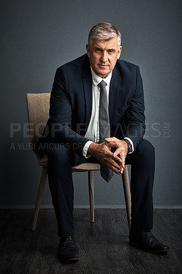 Buy stock photo Studio shot of a mature businessman posing against a grey background