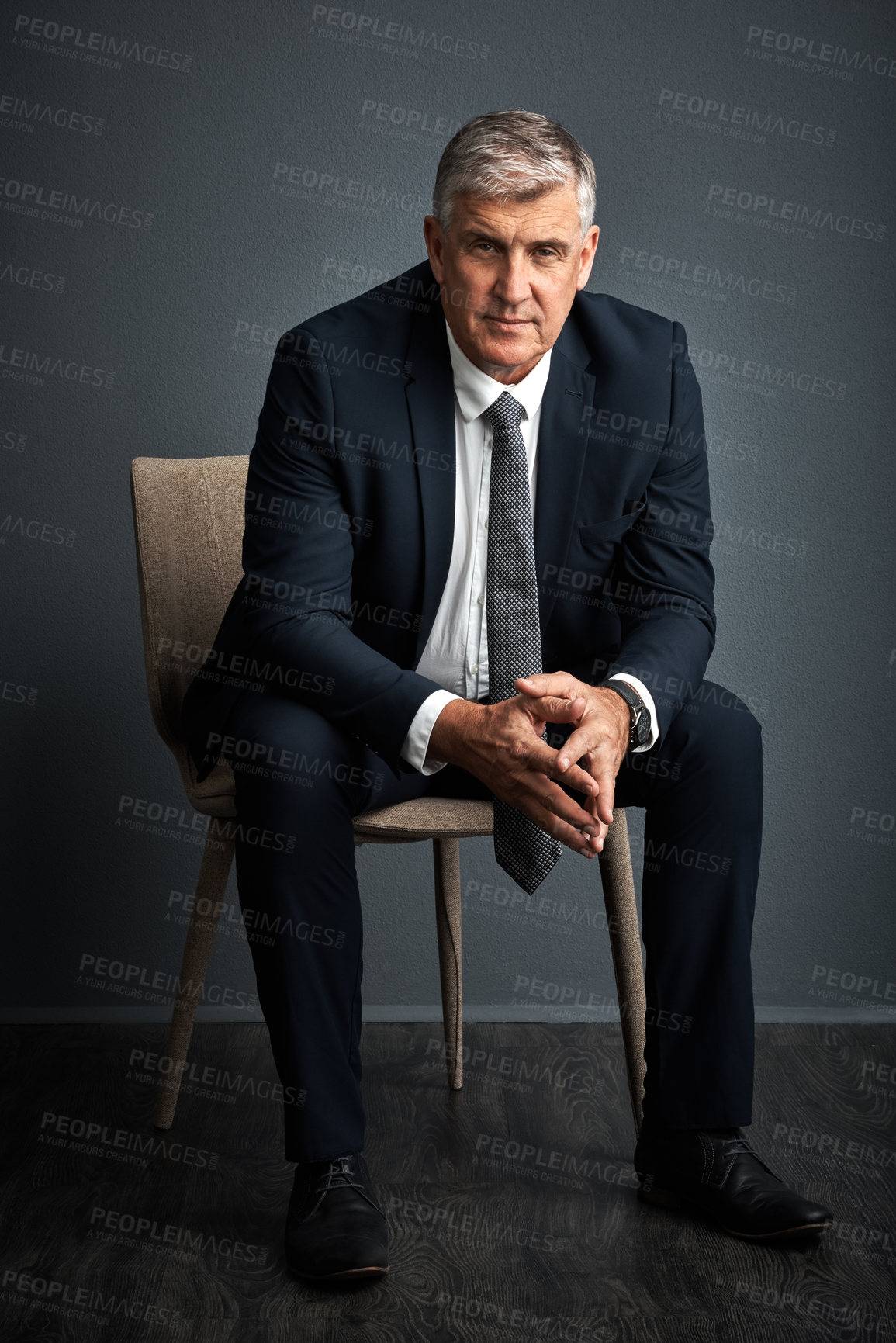 Buy stock photo Studio shot of a mature businessman posing against a grey background