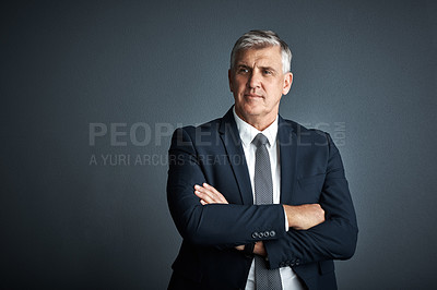 Buy stock photo Studio shot of a mature businessman posing against a grey background