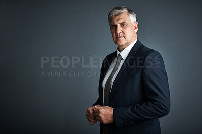 Buy stock photo Studio shot of a mature businessman posing against a grey background