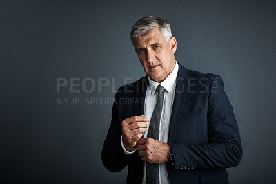 Buy stock photo Studio shot of a mature businessman posing against a grey background