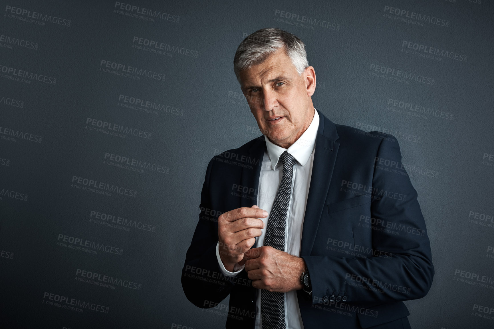 Buy stock photo Studio shot of a mature businessman posing against a grey background