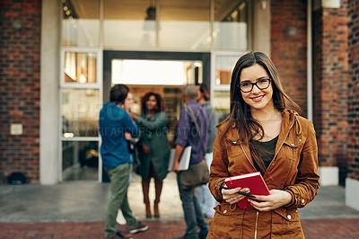 Buy stock photo Portrait of a happy young woman holding a notebook outdoors on campus