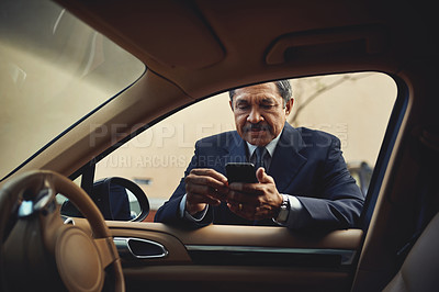 Buy stock photo Reading, car and mature man with cellphone, serious and business person in morning, online or texting. Outdoor, communication and ready to travel to work, vehicle or boss in sales with mobile