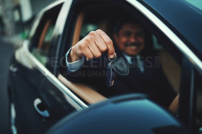 Buy stock photo Shot of a businessman holding the keys to a luxury car