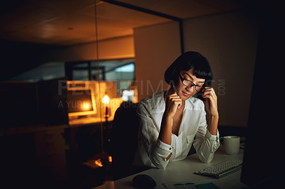 Buy stock photo Shot of a young businesswoman feeling tired during a late night at work