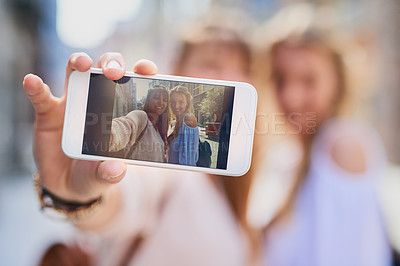 Buy stock photo Phone screen, women and selfie of happy friends in city for travel, tourism or holiday. Girls, mobile or picture in urban street for vlog, blog post or vacation memory of influencer with hand closeup