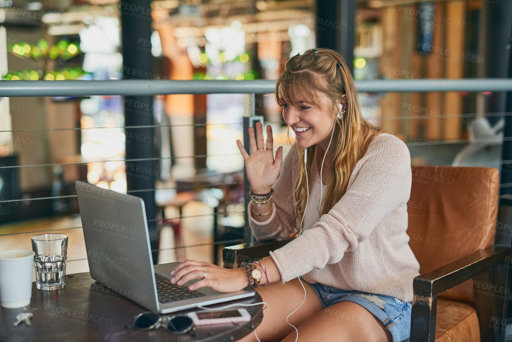 Buy stock photo Cropped shot of an attractive young woman using her laptop while sitting in a cafe